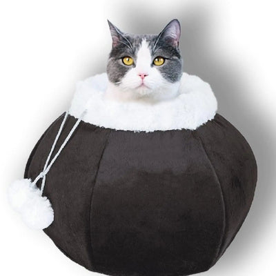 Round brown plush cat bed for indoor cats with removable pillow and hanging fluffy balls