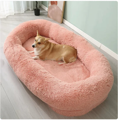 Large plush winter pet bed in pink with a small dog resting inside