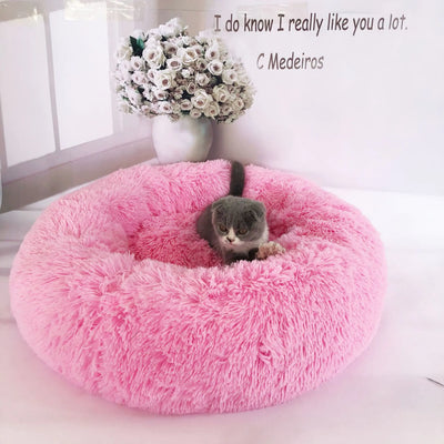 Pink removable and washable plush pet bed with a gray cat inside