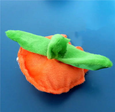 Plush Halloween pumpkin toy with green stem on blue background